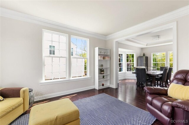 living area with crown molding, dark wood-style floors, and baseboards