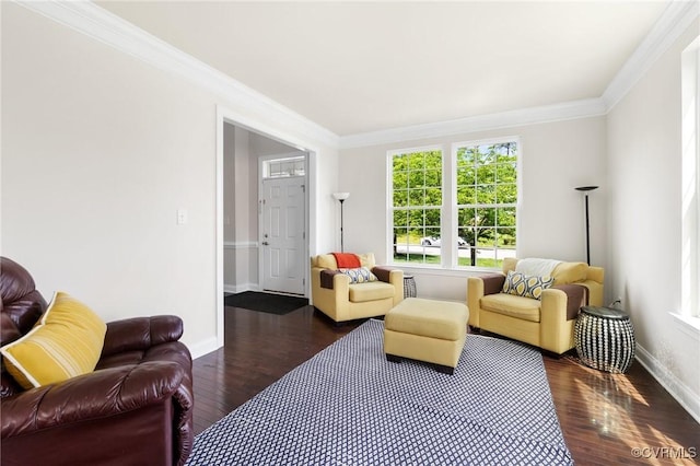 living area with ornamental molding, a wealth of natural light, wood finished floors, and baseboards