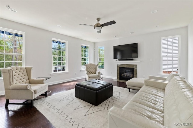 living room featuring ceiling fan, baseboards, a tile fireplace, recessed lighting, and wood finished floors