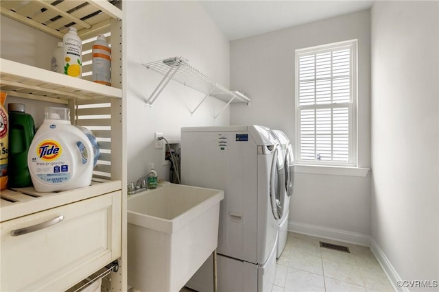 laundry room with washer and dryer, plenty of natural light, laundry area, and a sink