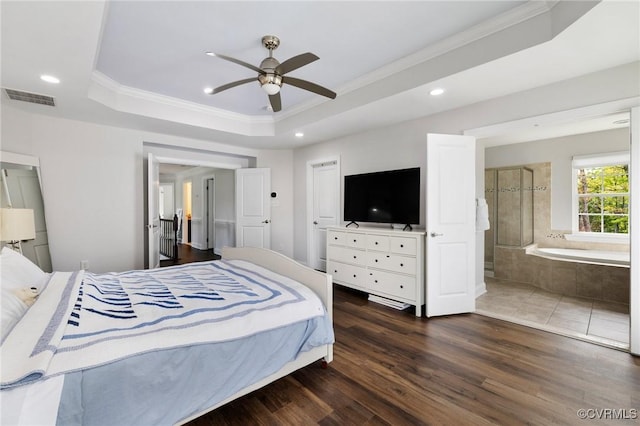 bedroom with recessed lighting, wood finished floors, visible vents, a raised ceiling, and crown molding