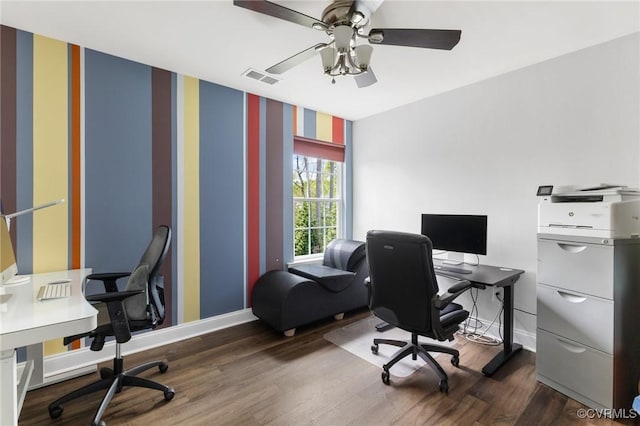 home office featuring dark wood-type flooring, visible vents, ceiling fan, and baseboards