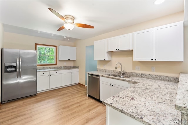 kitchen featuring ceiling fan, appliances with stainless steel finishes, a sink, white cabinetry, and light wood-type flooring