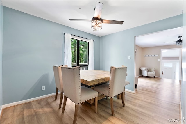 dining room with ceiling fan, baseboards, and light wood finished floors