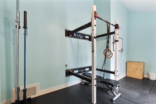 workout room featuring baseboards and visible vents