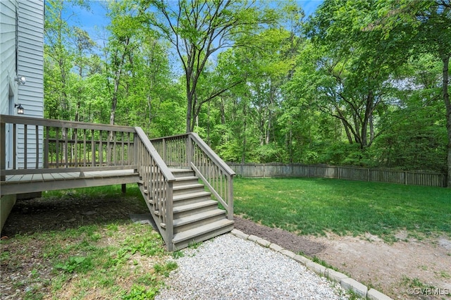 view of yard with stairs, a fenced backyard, and a wooden deck