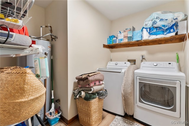 laundry area with independent washer and dryer, laundry area, and wood finished floors