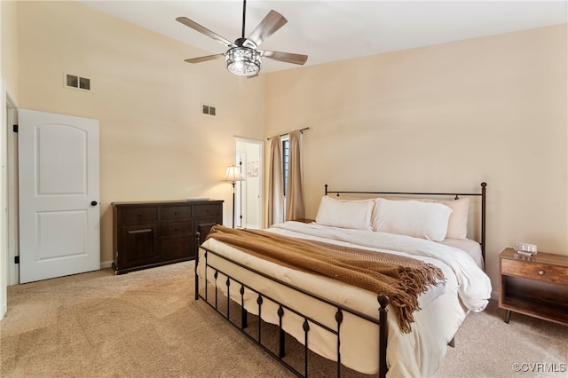 bedroom featuring high vaulted ceiling, ceiling fan, light carpet, and visible vents