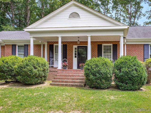 1735 Old Powhatan Ests, Powhatan, VA 23139 - greek revival inspired property featuring brick siding, covered porch, and a front lawn