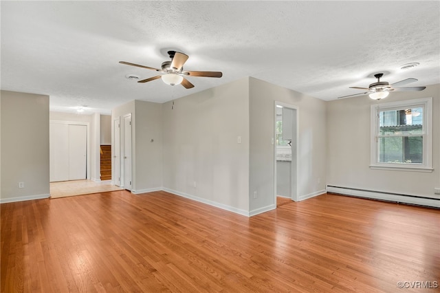 13101 Harrowgate Rd, Chester, VA 23831 - spare room with a ceiling fan, light wood-style floors, a textured ceiling, baseboards, and a baseboard radiator