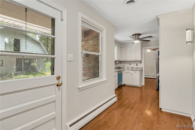 13101 Harrowgate Rd, Chester, VA 23831 - doorway featuring baseboard heating, wood finished floors, and healthy amount of natural light