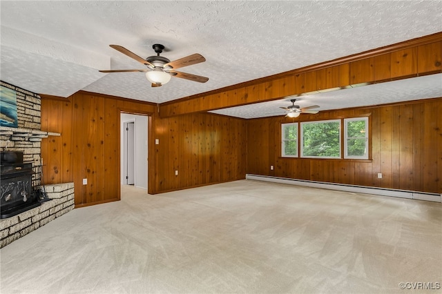 13101 Harrowgate Rd, Chester, VA 23831 - unfurnished living room featuring a ceiling fan, a baseboard heating unit, carpet, a textured ceiling, and wood walls