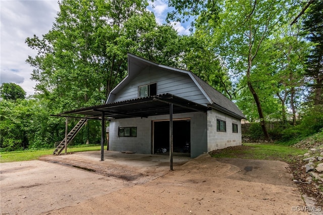13101 Harrowgate Rd, Chester, VA 23831 - view of front of home featuring a gambrel roof, stairs, concrete block siding, and a carport