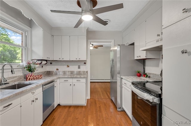 13101 Harrowgate Rd, Chester, VA 23831 - kitchen with stainless steel appliances, a sink, ceiling fan, under cabinet range hood, and white cabinetry