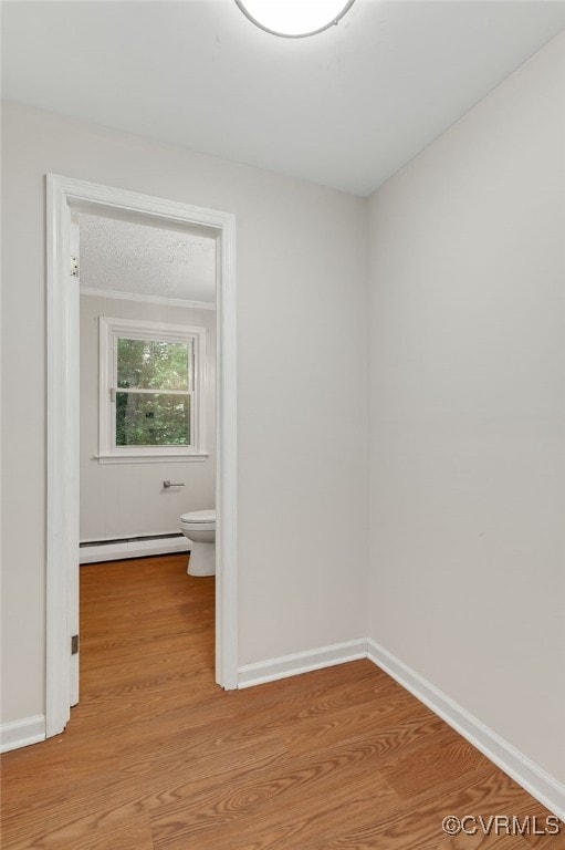 13101 Harrowgate Rd, Chester, VA 23831 - spare room with a baseboard heating unit, light wood-style floors, and baseboards