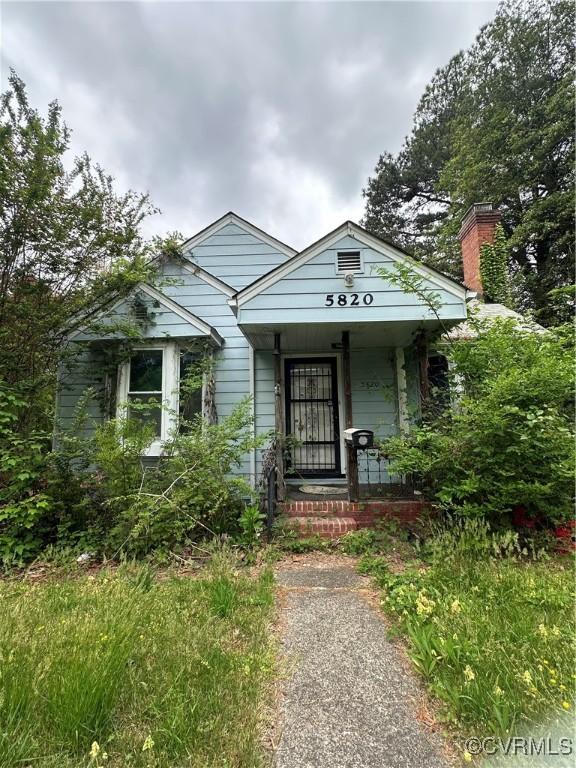 5820 Hermitage Rd, Henrico, VA 23228 - bungalow-style house with covered porch and a chimney