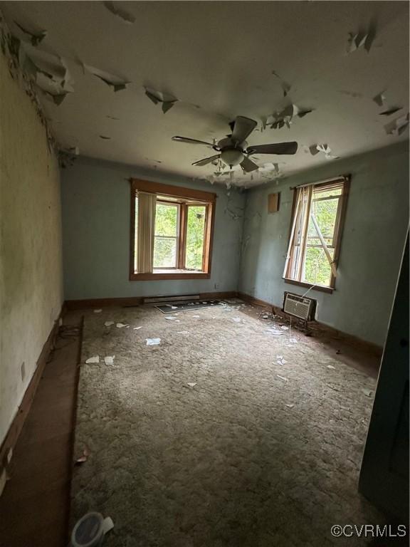 5820 Hermitage Rd, Henrico, VA 23228 - spare room featuring ceiling fan, a wall mounted AC, and plenty of natural light