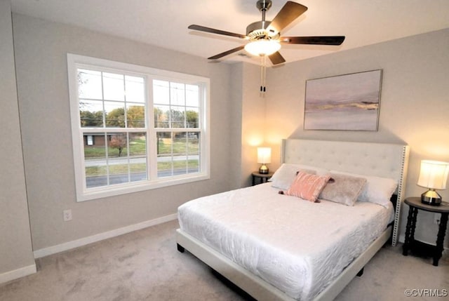carpeted bedroom featuring ceiling fan and baseboards