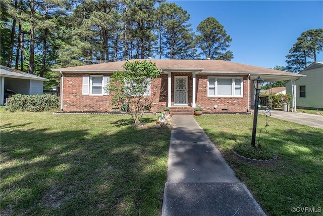 view of front of home with brick siding, a front yard, concrete driveway, and a carport
