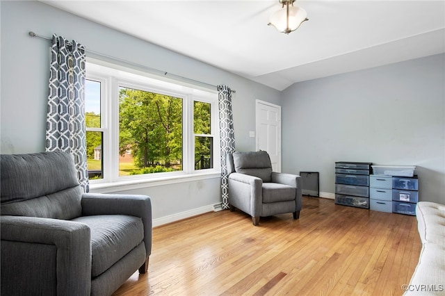 living area with light wood-type flooring and baseboards