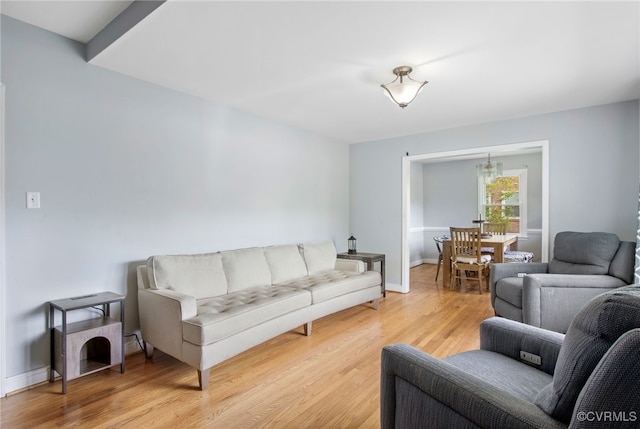 living area with light wood-style floors and baseboards
