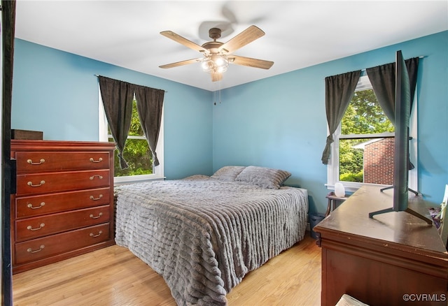 bedroom with light wood-style floors and ceiling fan