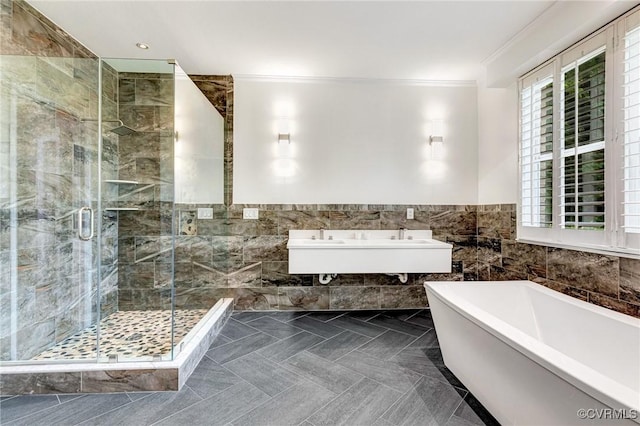 9073 Pine Hill Rd, Mechanicsville, VA 23116 - full bathroom featuring a freestanding tub, tile walls, crown molding, a shower stall, and a wainscoted wall