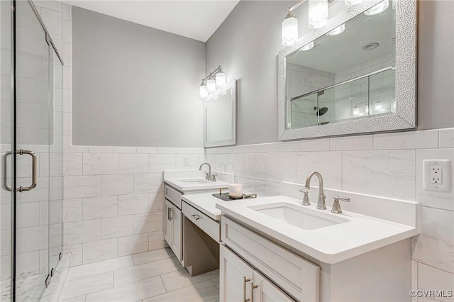 9073 Pine Hill Rd, Mechanicsville, VA 23116 - bathroom with a stall shower, tile walls, two vanities, and a wainscoted wall