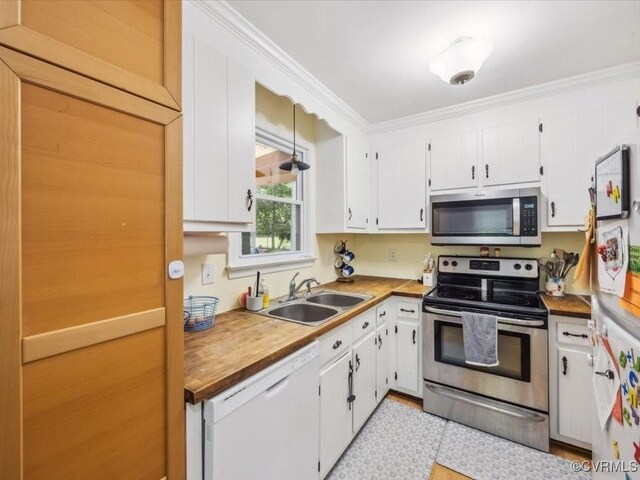 kitchen featuring a sink, white cabinets, and stainless steel appliances