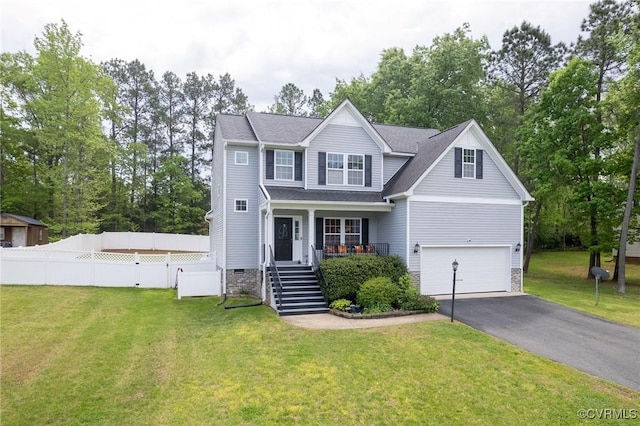 traditional-style house with a front yard, stairway, aphalt driveway, an attached garage, and fence