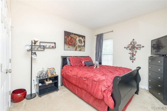 bedroom with light carpet and baseboards
