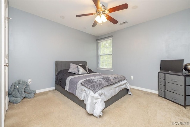 bedroom with baseboards, visible vents, ceiling fan, and light colored carpet