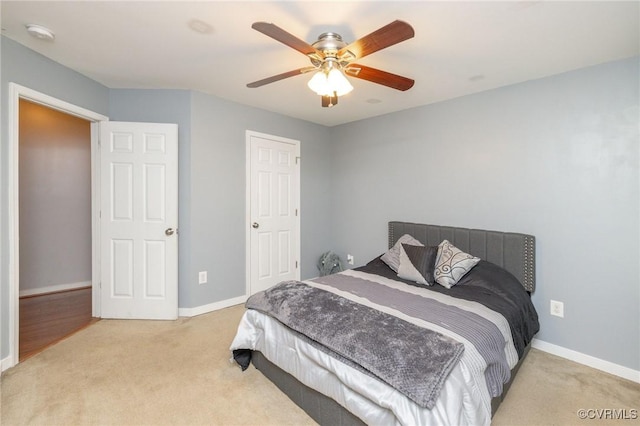 carpeted bedroom with baseboards and ceiling fan