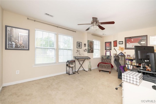home office with carpet flooring, ceiling fan, baseboards, and visible vents