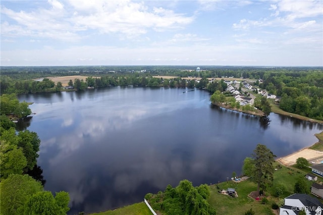 aerial view with a water view and a wooded view