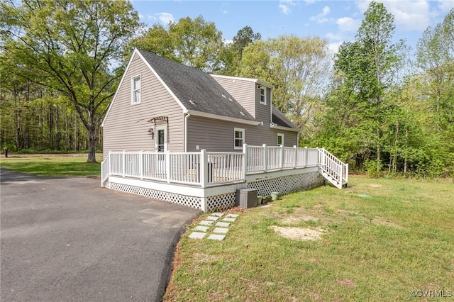 15131 Burruss Ln, Ruther Glen, VA 22546 - view of home's exterior with roof with shingles, a yard, central AC, and a wooden deck