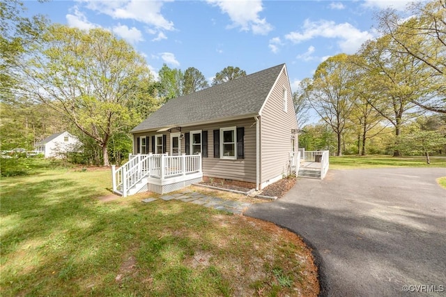 15131 Burruss Ln, Ruther Glen, VA 22546 - cape cod house with covered porch, asphalt driveway, a front lawn, a shingled roof, and crawl space