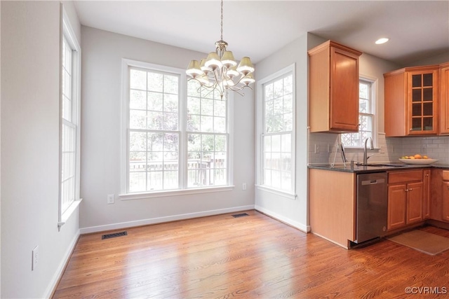 kitchen featuring a notable chandelier, light wood-style flooring, glass insert cabinets, dishwasher, and visible vents
