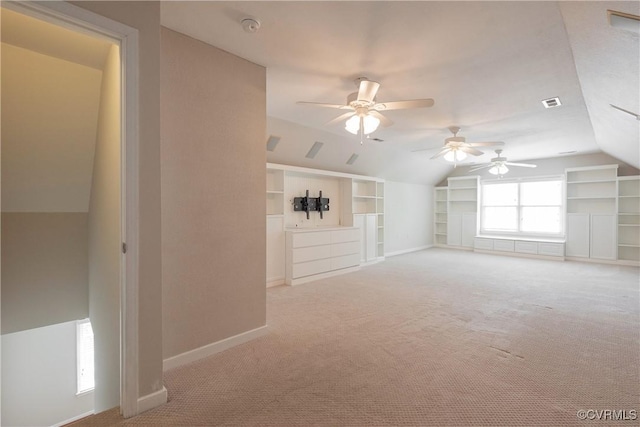 interior space with lofted ceiling, baseboards, visible vents, ceiling fan, and built in features