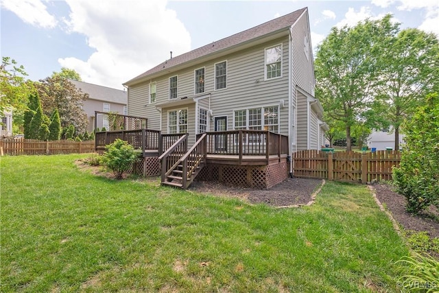 back of property featuring a yard, a wooden deck, and a fenced backyard