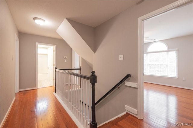 stairs with hardwood / wood-style flooring and baseboards