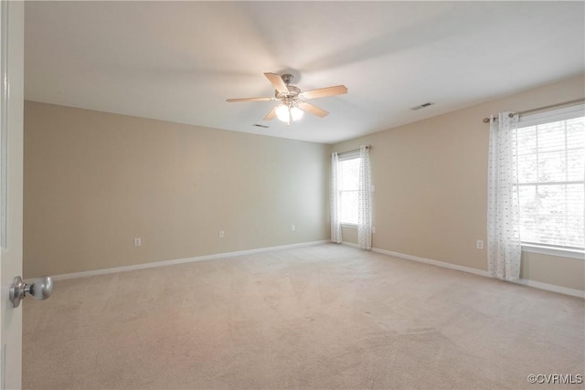unfurnished room featuring ceiling fan, light carpet, baseboards, and visible vents