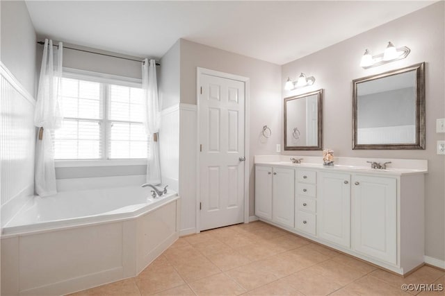 bathroom featuring double vanity, a garden tub, tile patterned flooring, and a sink