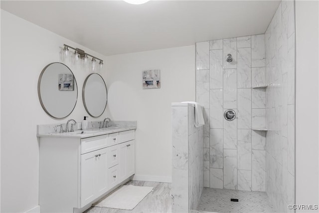 bathroom with a sink, a walk in shower, double vanity, and marble finish floor