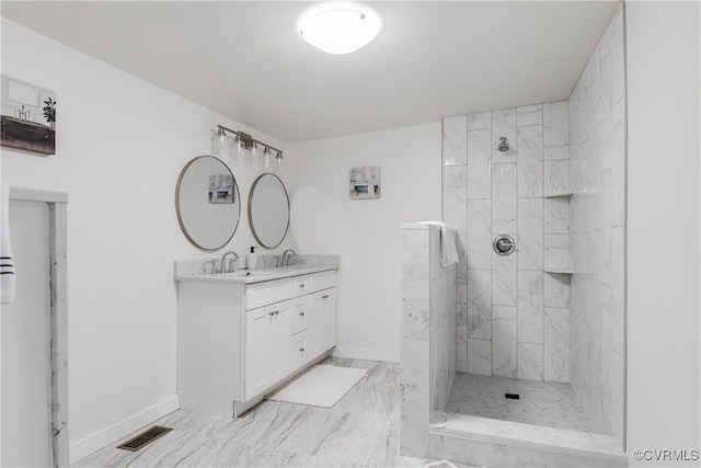bathroom with a walk in shower, baseboards, vanity, and visible vents