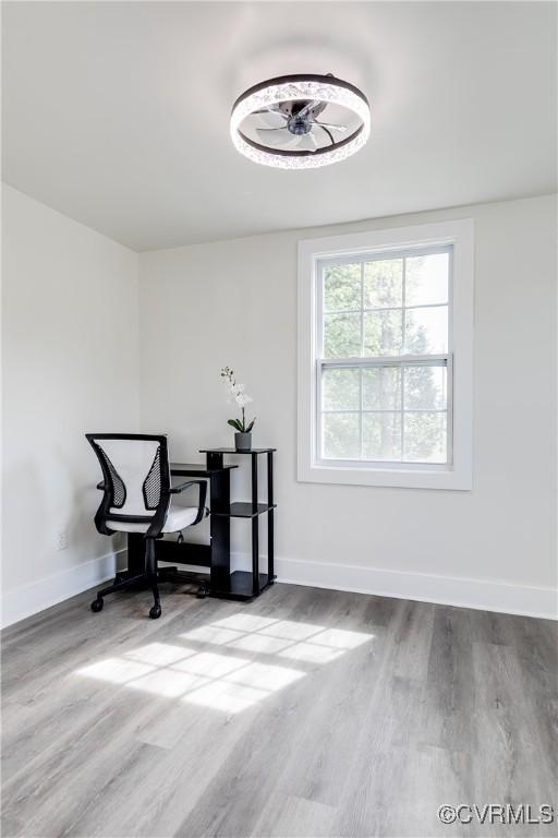 dining space with baseboards and wood finished floors