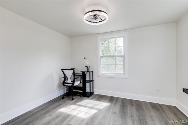 interior space with baseboards and wood finished floors