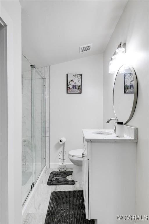bathroom featuring vanity, toilet, marble finish floor, a shower stall, and visible vents
