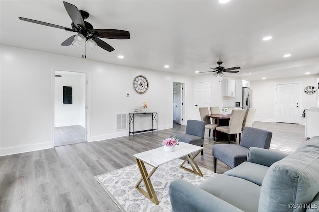 living area with recessed lighting, baseboards, ceiling fan, and visible vents