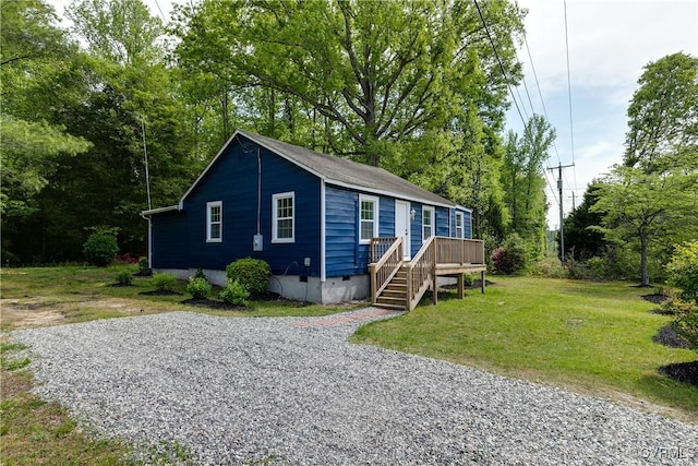view of front of property with a front yard, crawl space, and a deck